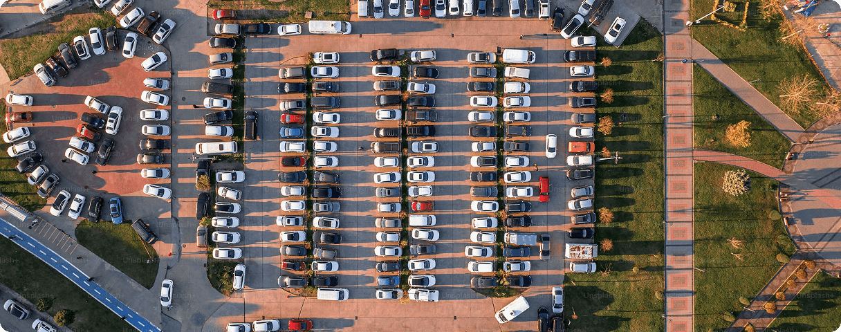 Aerial view of a car dealership lot filled with vehicles